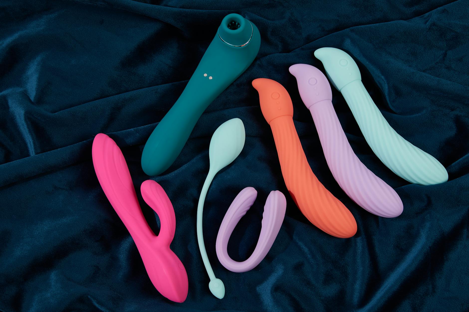 Pink lemon vibrator on purple background with romantic lighting